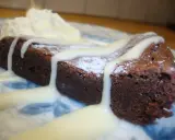 En bit chokladkaka med vispad grädde och vit chokladsås. En härlig vit kladdkaka som smälter i munnen.