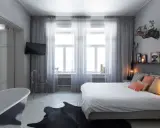 Sovrum med badkar, säng och en **gardin en sida** som ramar in fönstren.