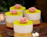 Fyra små prinsesstårta i glas, dekorerade med rosa marsipanrosor och gul marsipanlock. En festlig dessert.