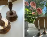 Två antika ljusstakar i mässing, redo att putsa. En kruka med rosa pelargoner står bredvid.