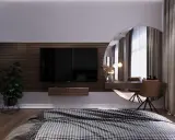 Snyggt sovrum med tv på träpanelvägg. Sminkbord med spegel och en bekväm fåtölj.