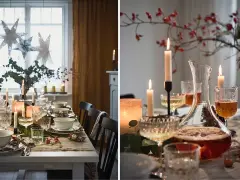 En fin juldukning med stjärnor i fönstret, levande ljus och en vacker karaff med dryck.