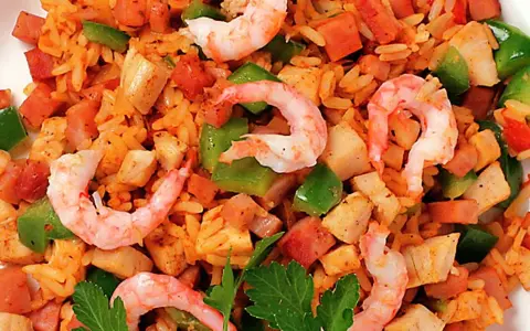 En närbild av en läcker jambalaya med ris, räkor, kyckling, korv och paprika. Perfekt för ett jambalaya recept!