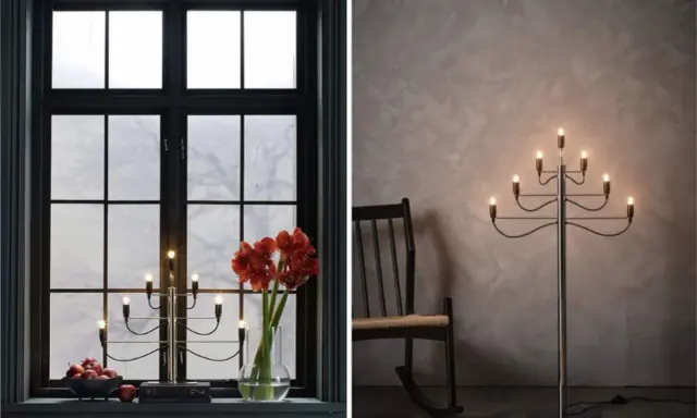 Två fina adventsljusstakar, en i ett mörkt fönster med amaryllis och äpplen, en annan som golvlampa bredvid en gungstol.