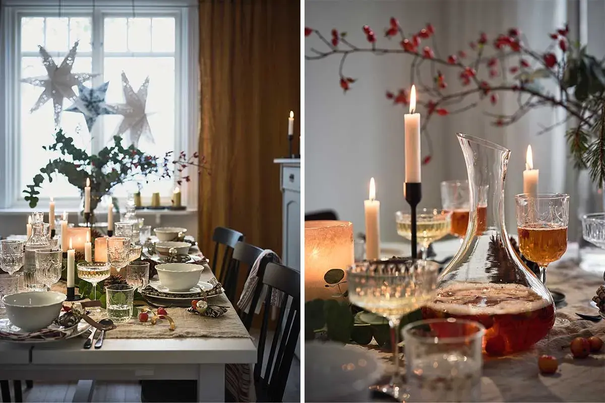 En fin juldukning med stjärnor i fönstret, levande ljus och en vacker karaff med dryck.